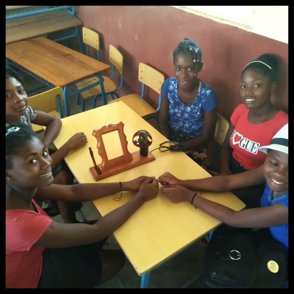 A group of young people sitting at a table.