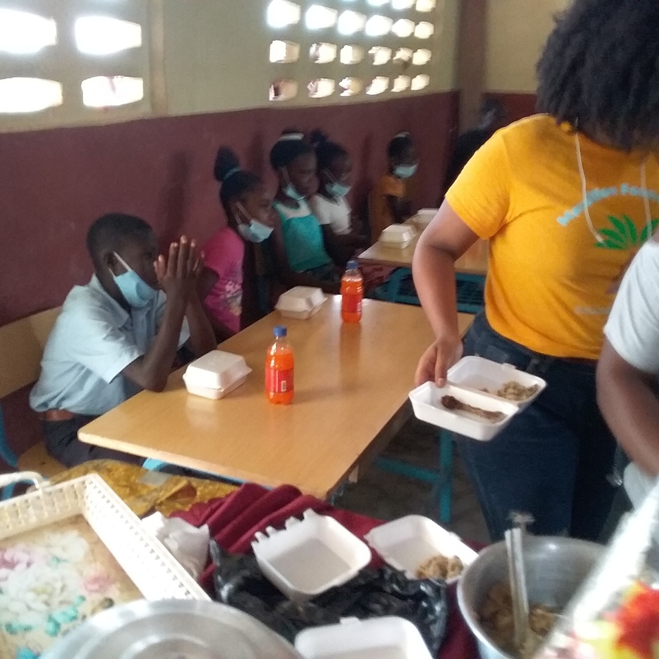 A group of people sitting at tables with food.