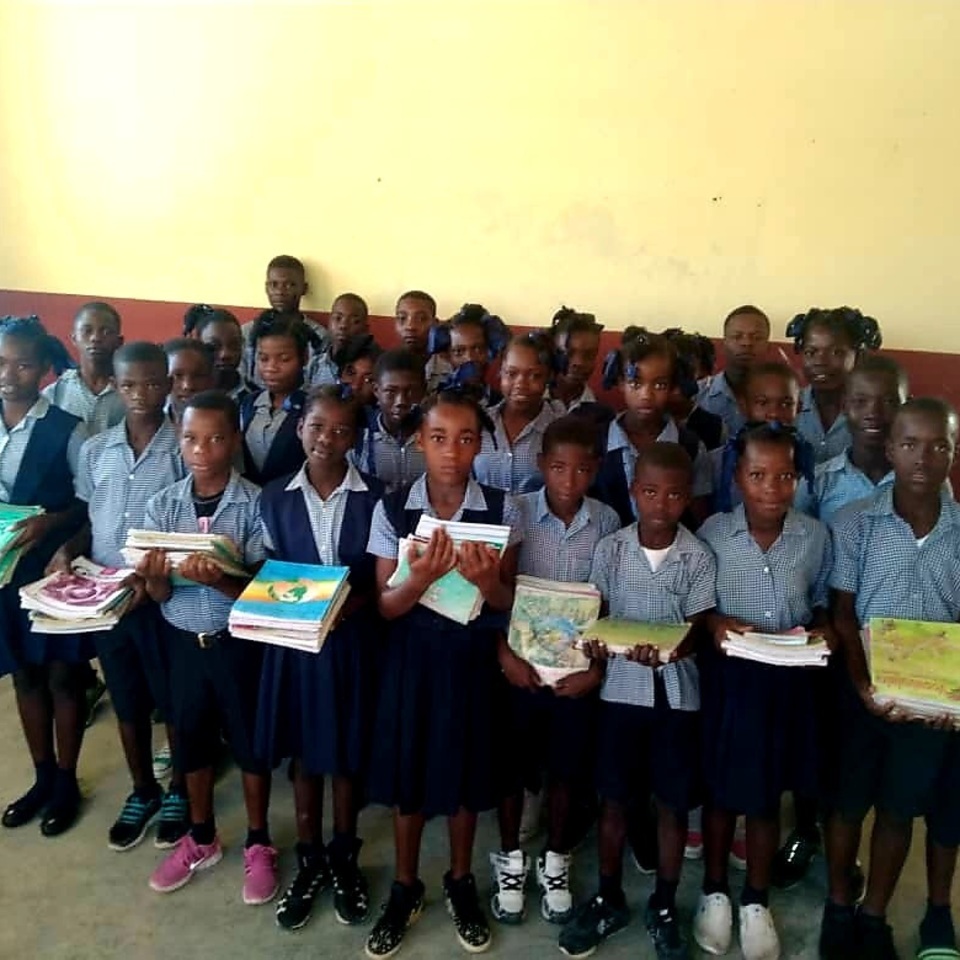 A group of children holding boxes in front of them.