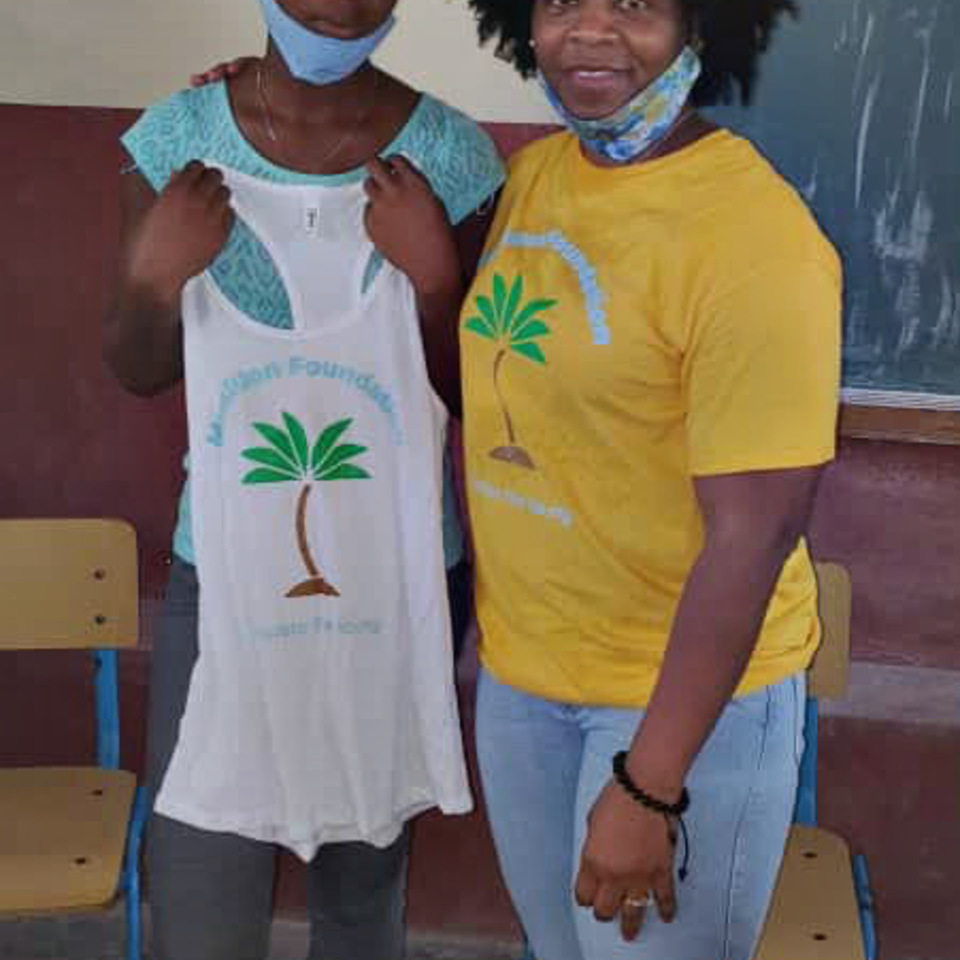 Two women standing next to each other in a classroom.