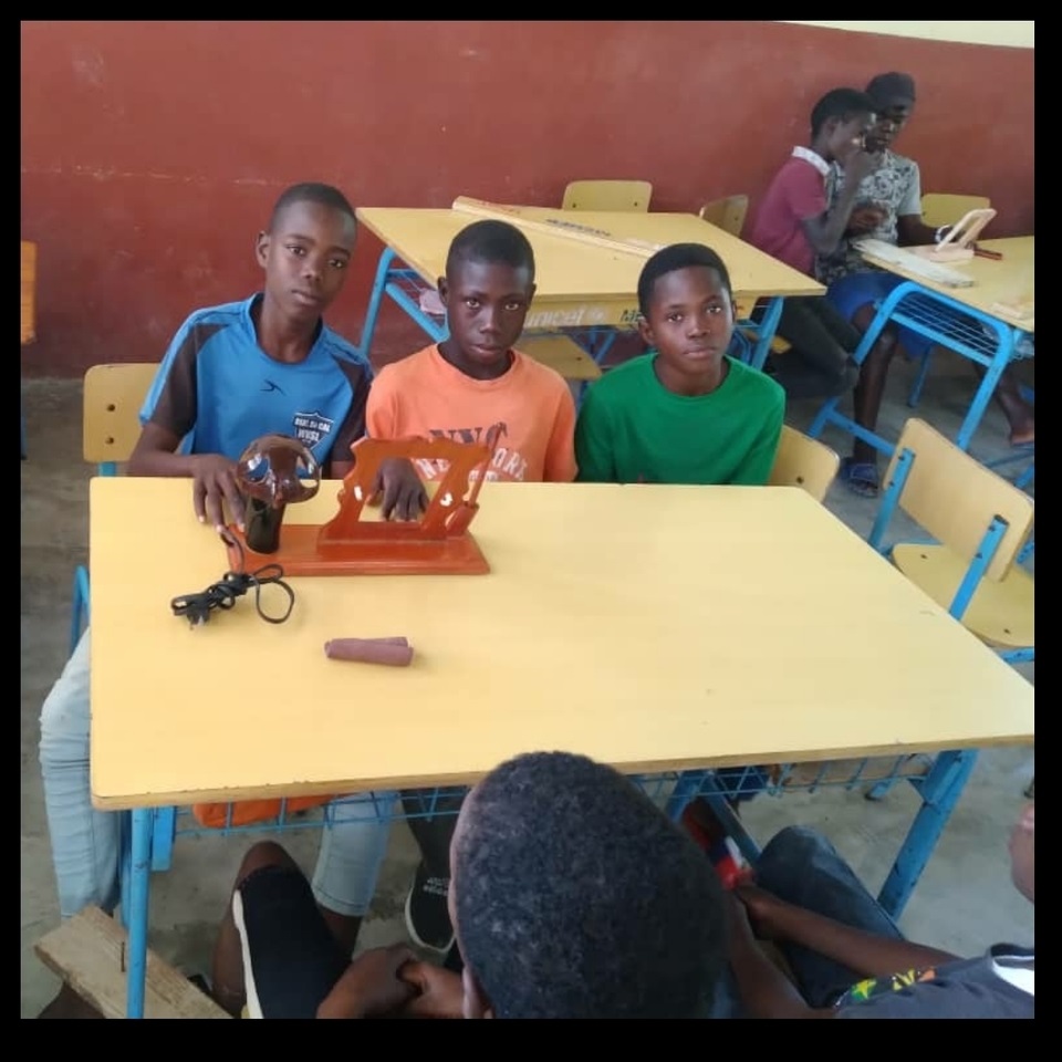 A group of young boys sitting at a table.