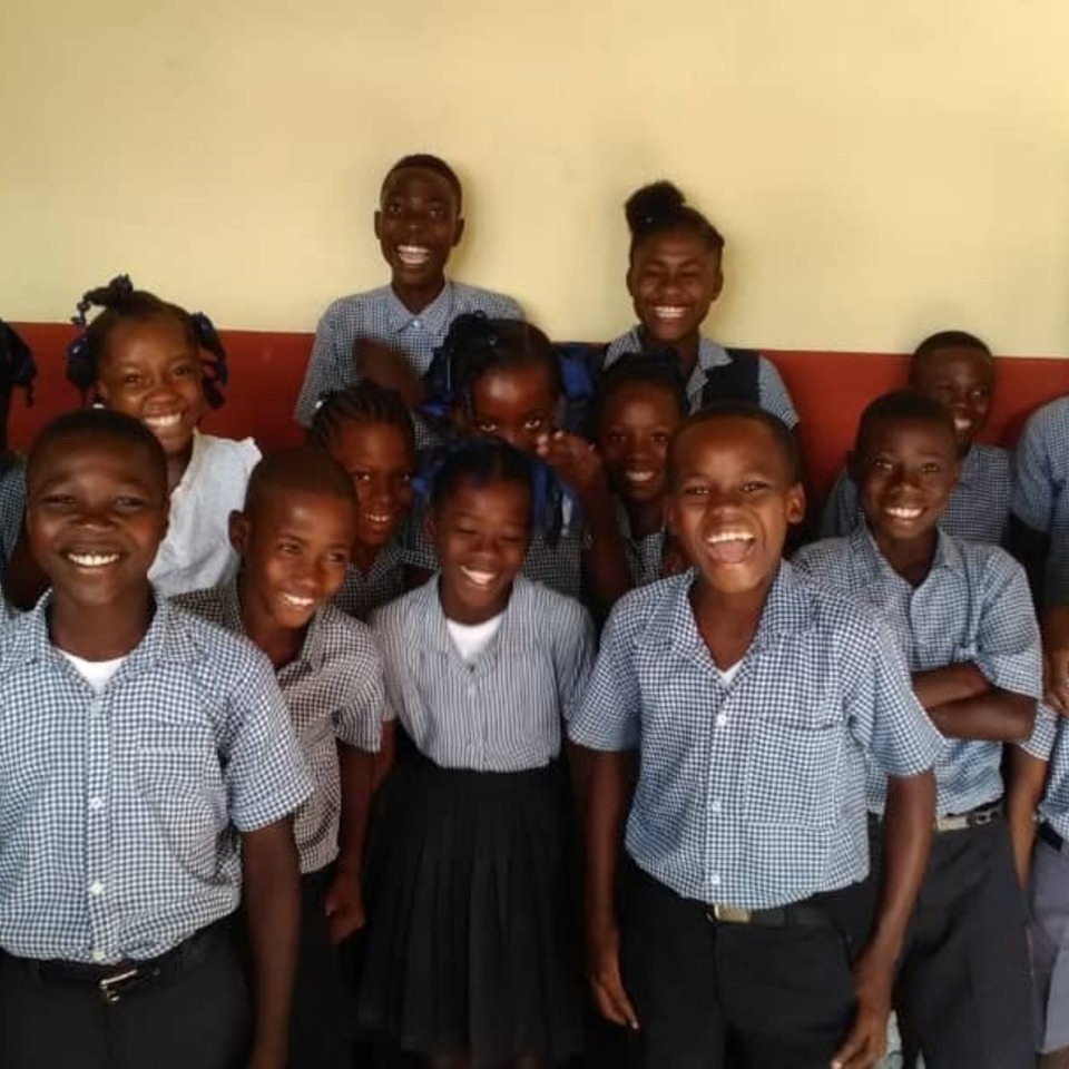 A group of children posing for the camera.