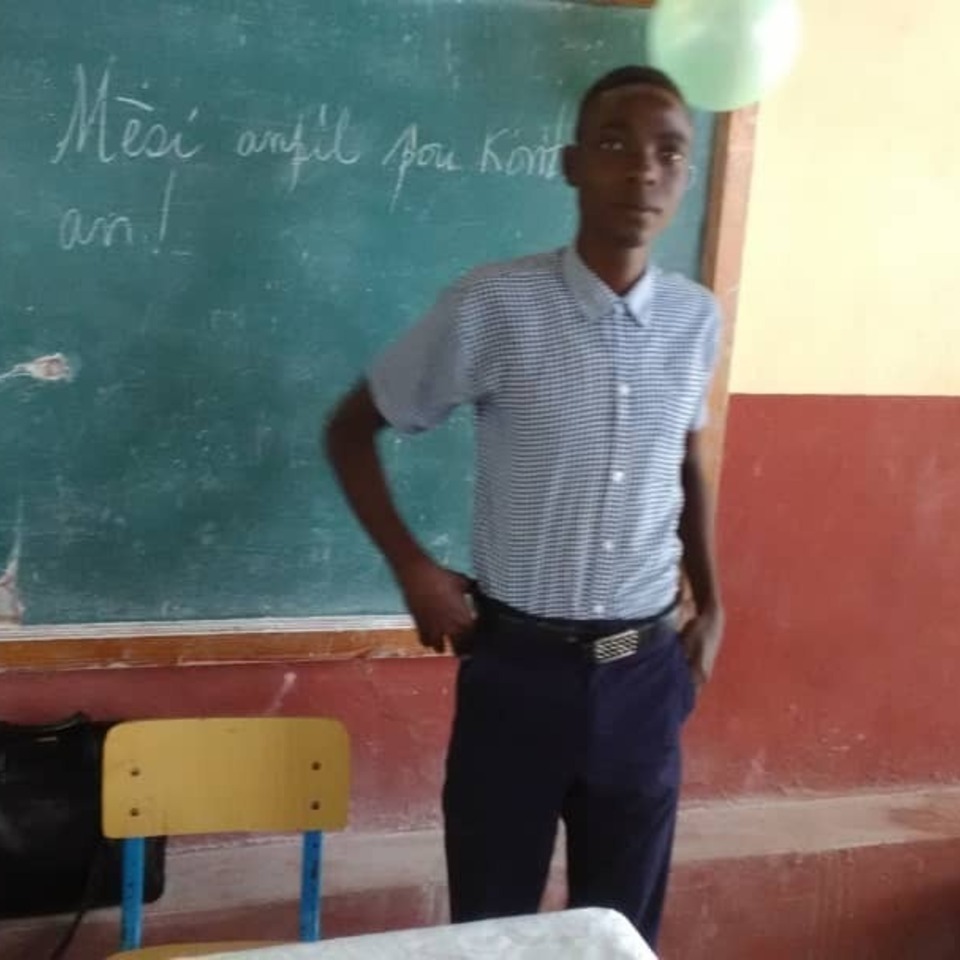 A man standing in front of a chalkboard.