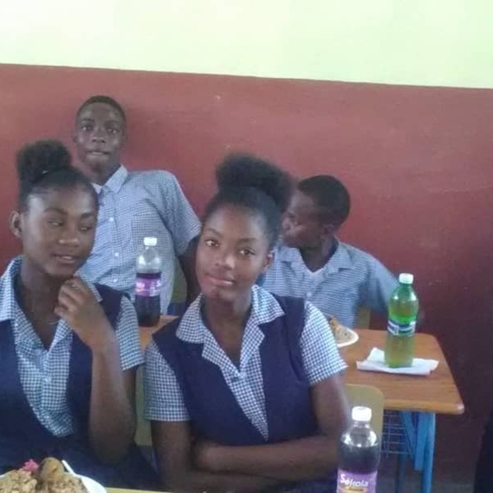 A group of young people sitting at a table.