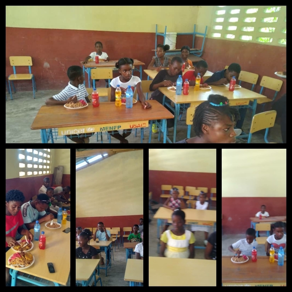 A group of people sitting at tables eating food.