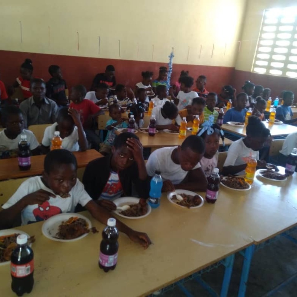 A group of people sitting at a table eating food.