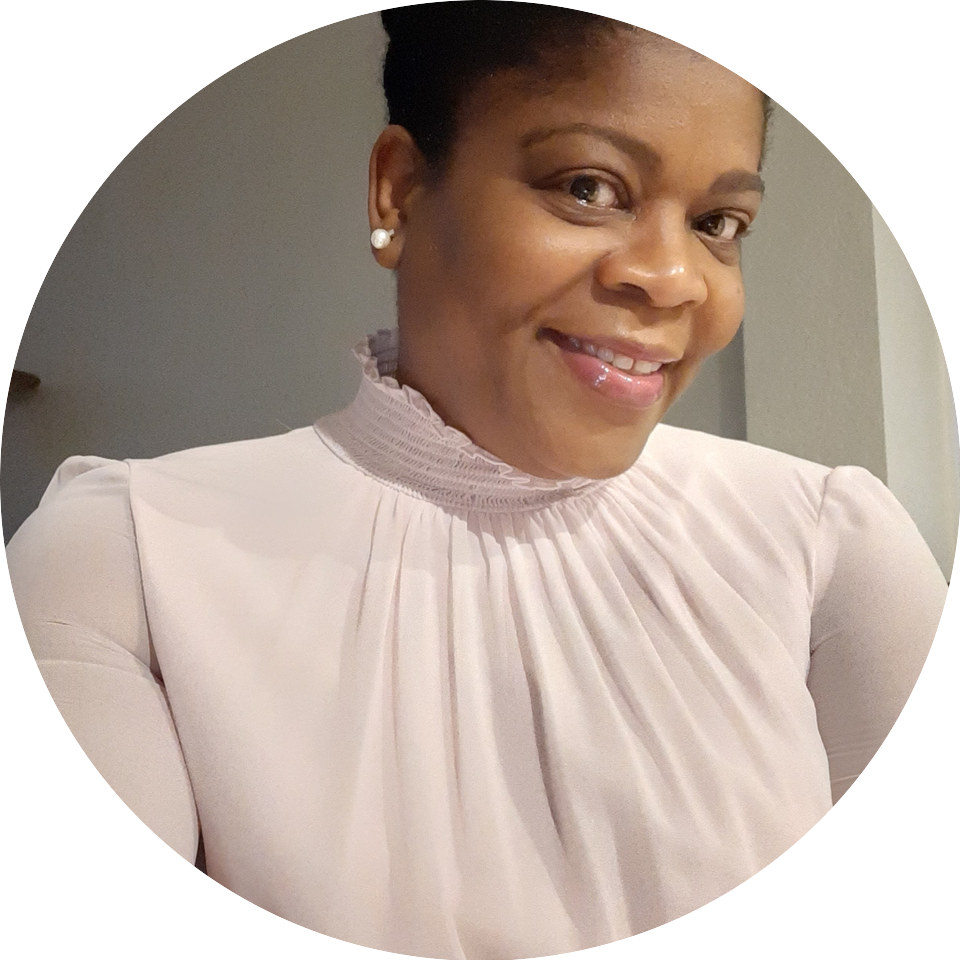 A woman in a white blouse smiling for the camera.