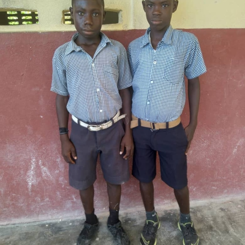 Two young men standing next to each other.