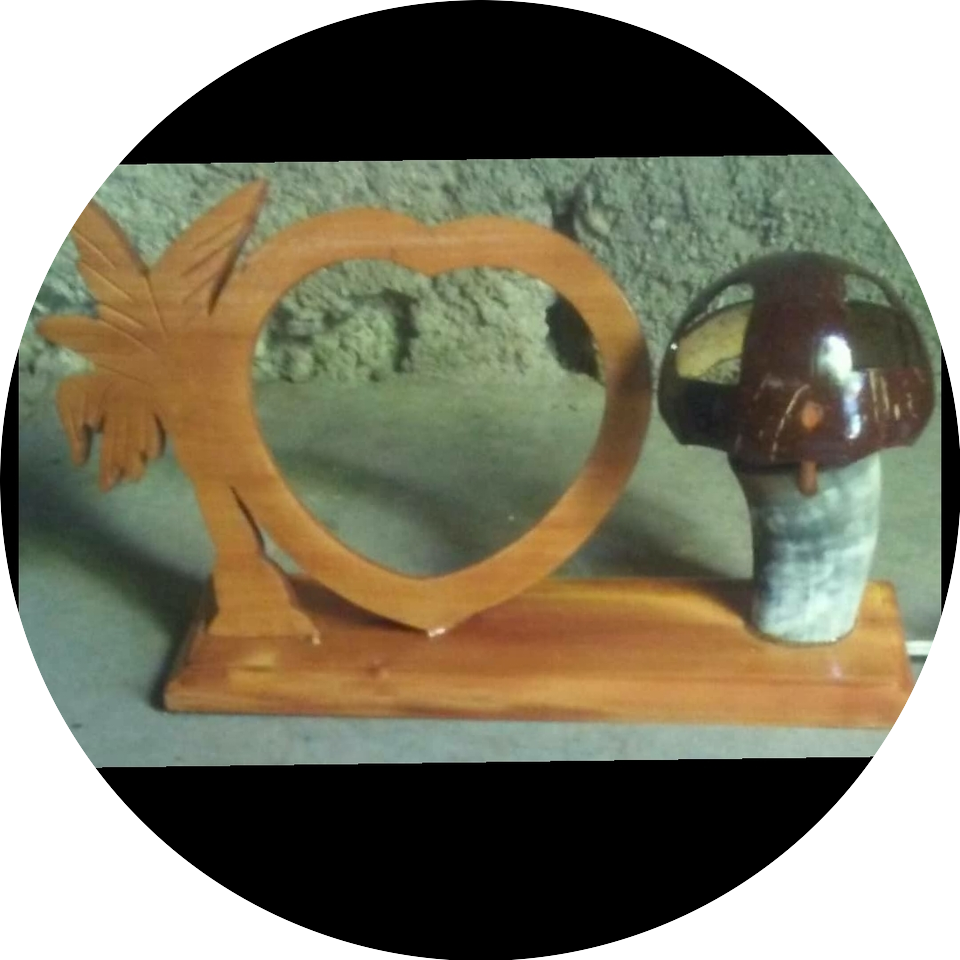 A wooden picture frame with a statue of a monkey.