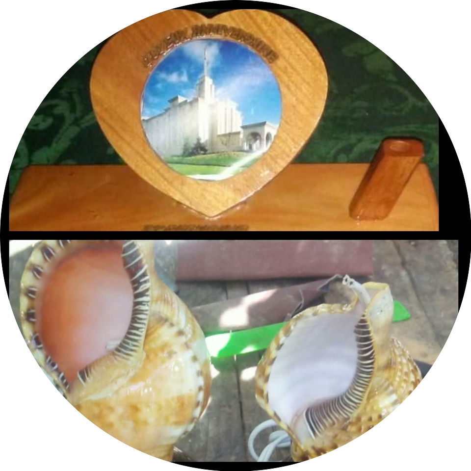 A picture of the temple and shells are in front of a wooden heart.