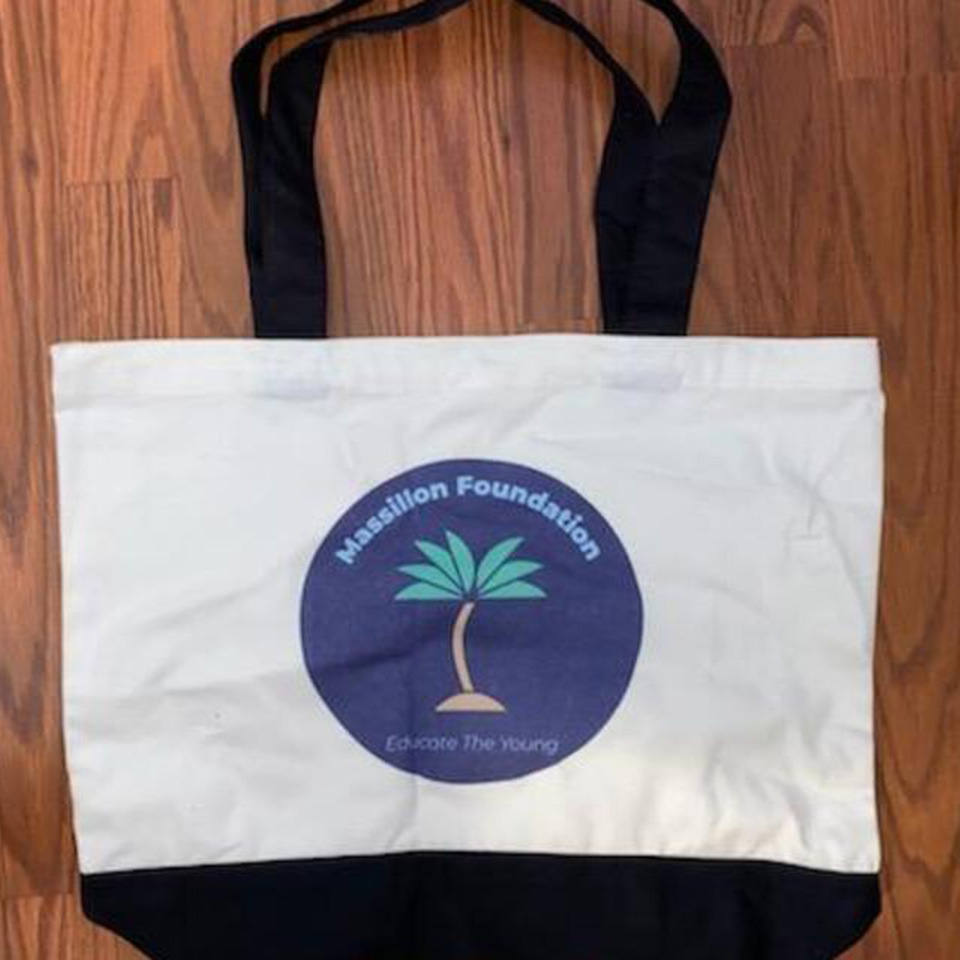 A bag that is on the ground with a palm tree logo.