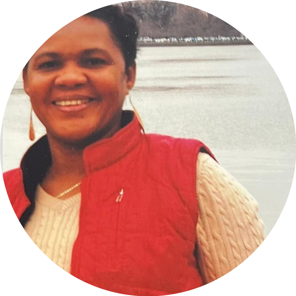 A woman in red vest smiling for the camera.