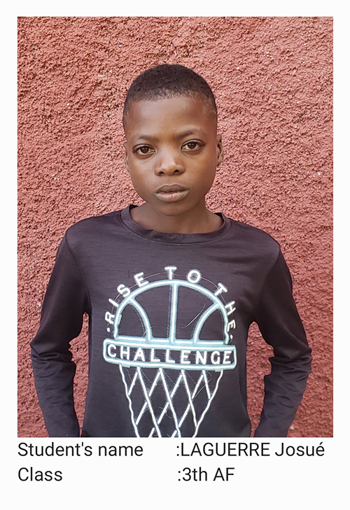 A young boy wearing a black shirt with a basketball on it.