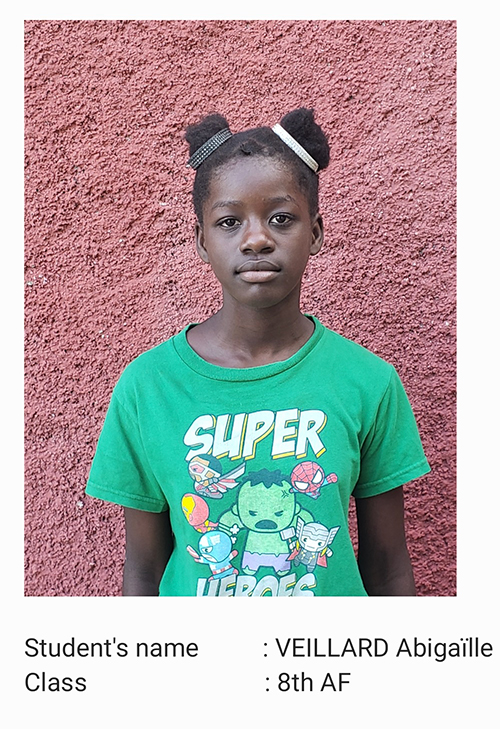 A young girl wearing a green shirt and black hair.