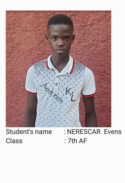 A young man standing in front of a wall.