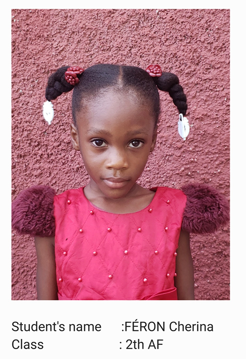 A young girl in pink dress with pigtails.