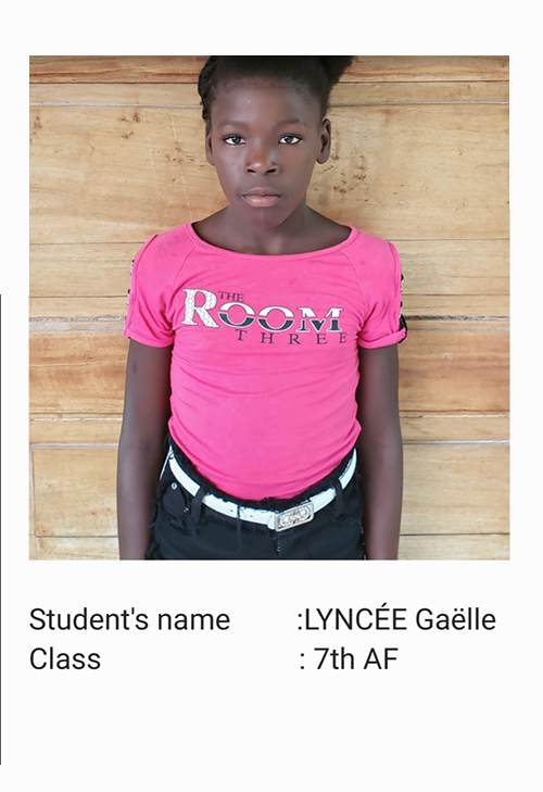 A young girl wearing a pink shirt and black belt.