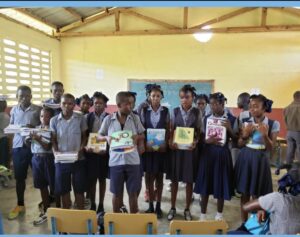 Students in classroom holding textbooks.