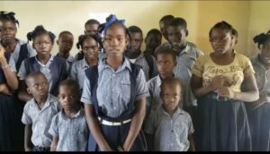 Group of children in school uniforms.